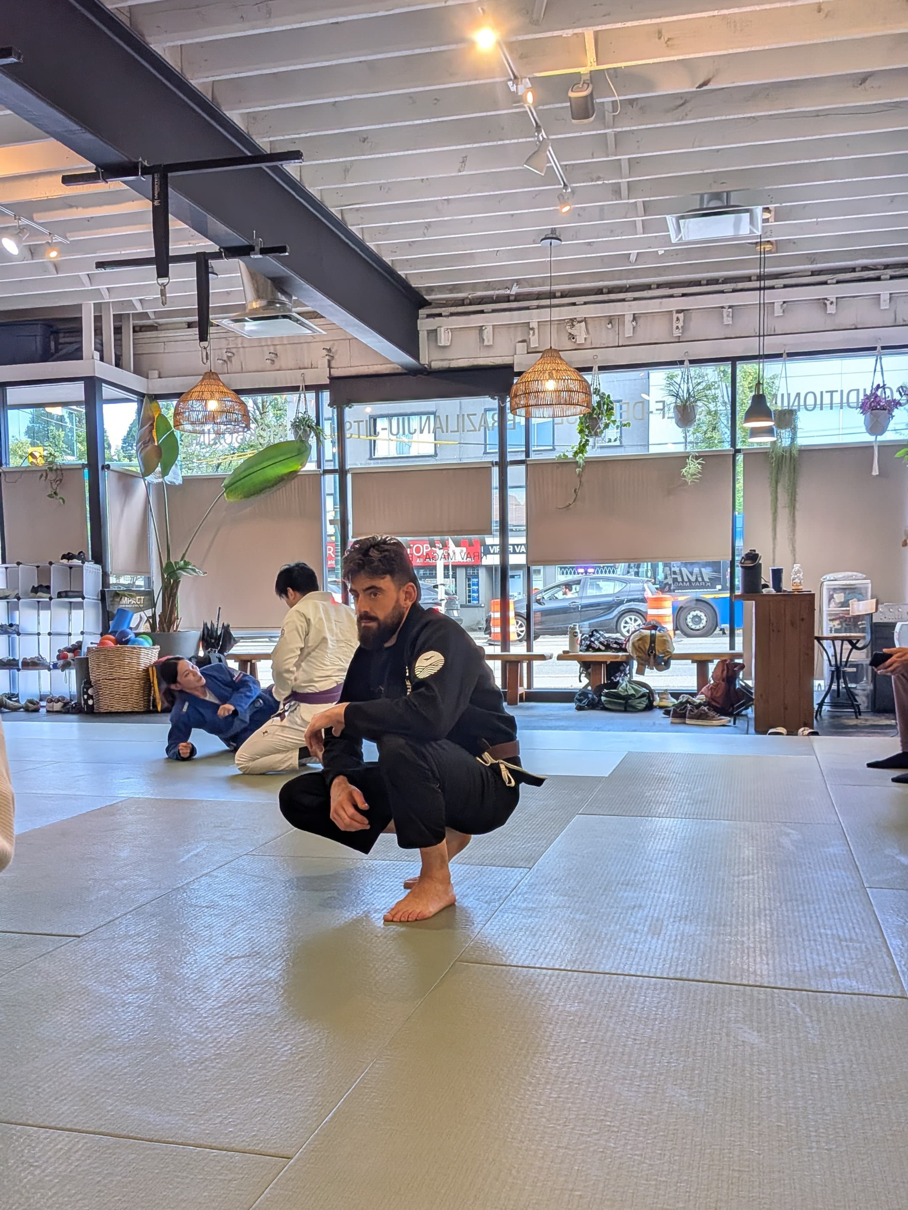 Shinsei Gi from The Hills Jiu Jitsu by Gentle Art Collective, white martial arts uniform with logo details on the chest and sleeves.