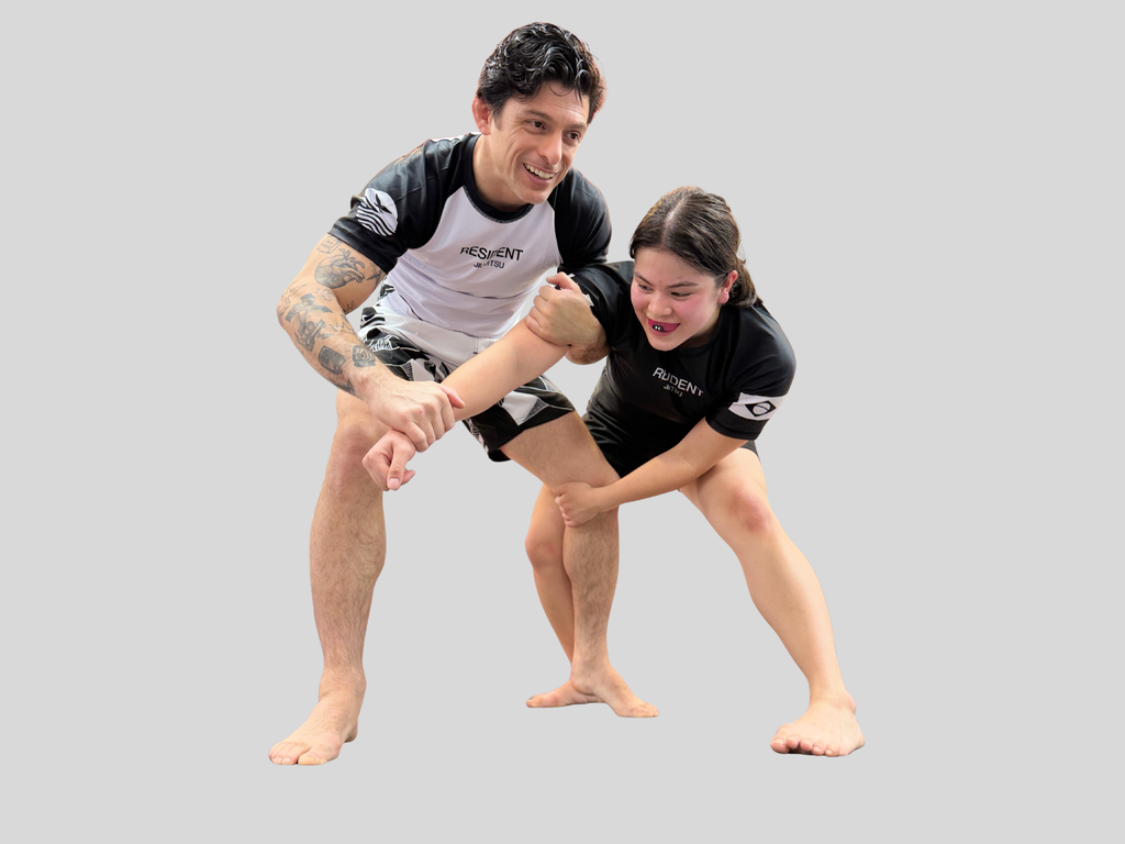 Gentle Art Collective rash guard featuring bold designs, worn by a martial artist in a jiu jitsu training session.