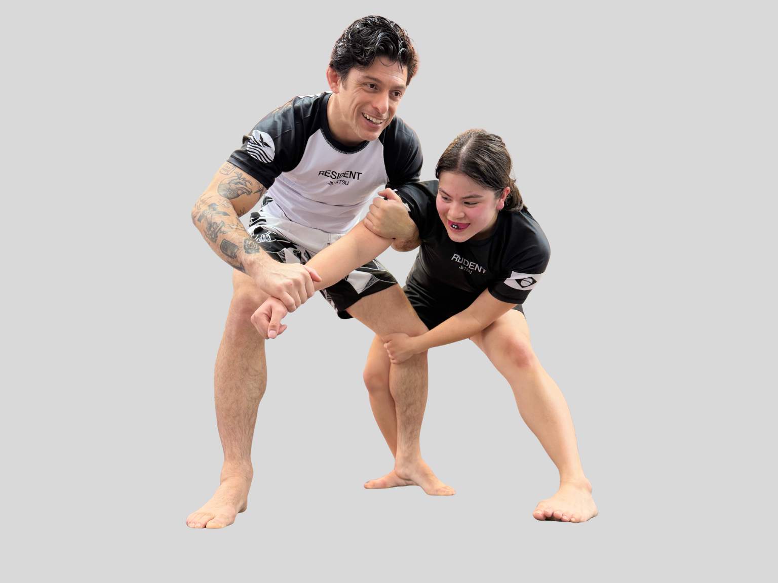 Gentle Art Collective rash guard featuring bold designs, worn by a martial artist in a jiu jitsu training session.