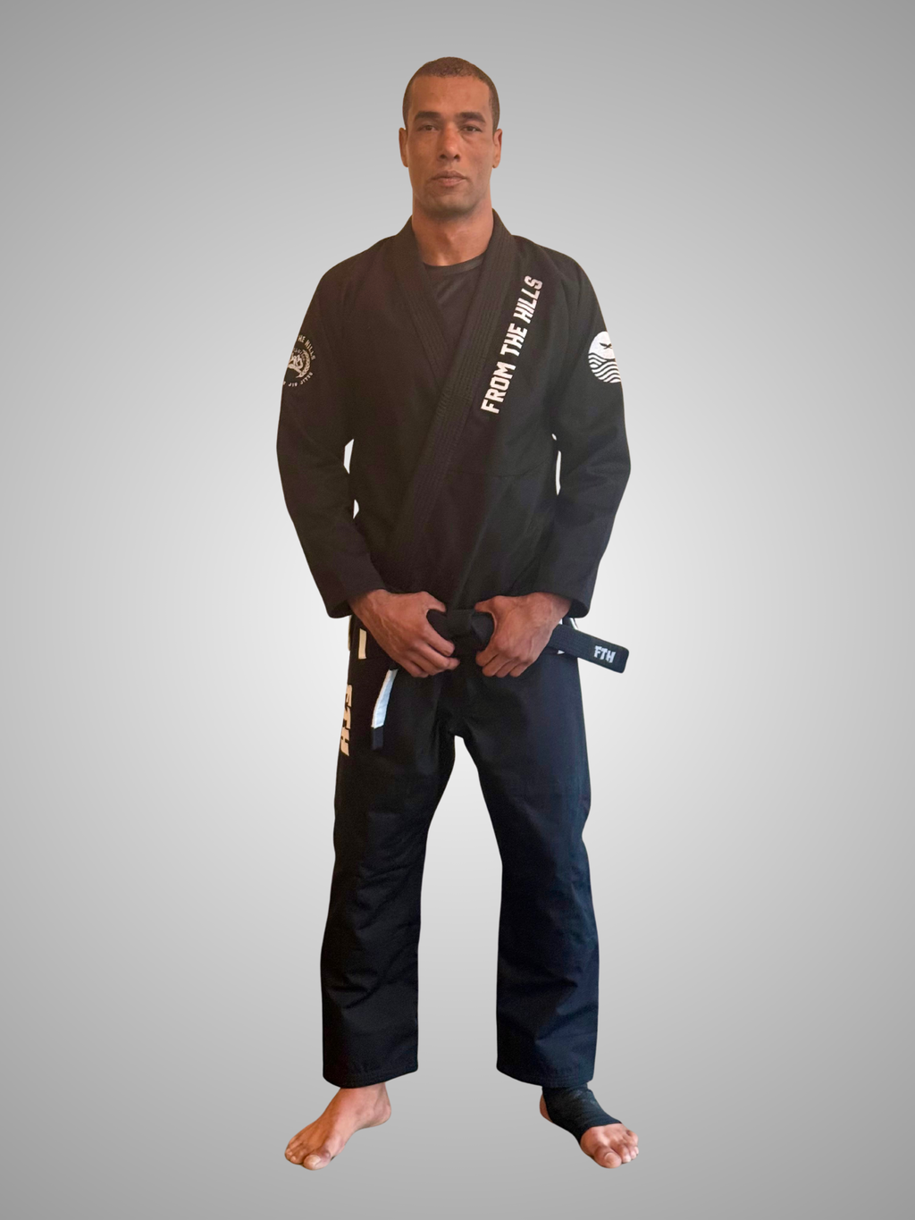 Gentle Art Collective Shinsei Gi from From The Hills Jiu Jitsu, white martial arts uniform with black accents and logo details