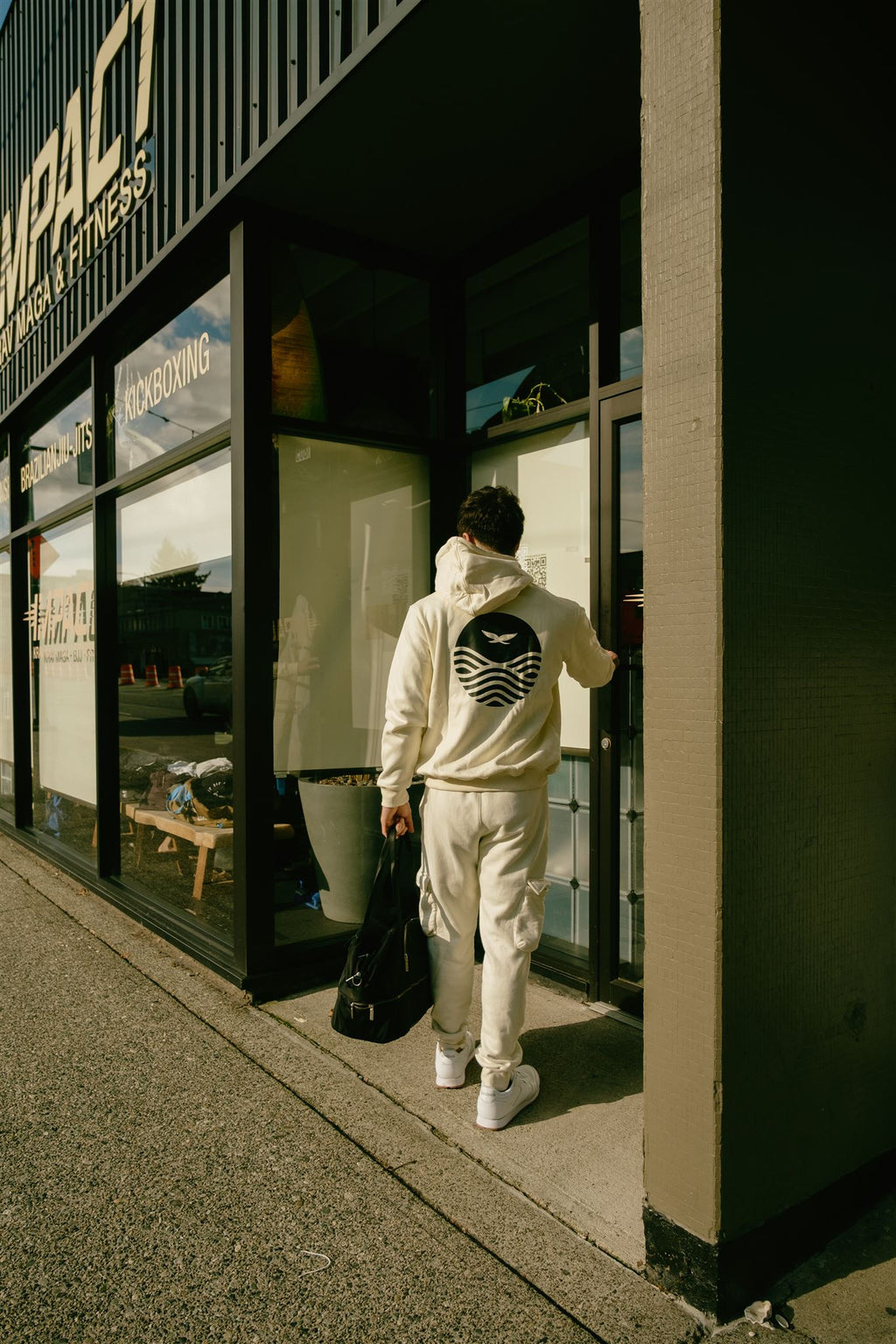 Gentle Art Collective ivory STANCE joggers displayed on a hanger, showcasing their relaxed fit and soft fabric.